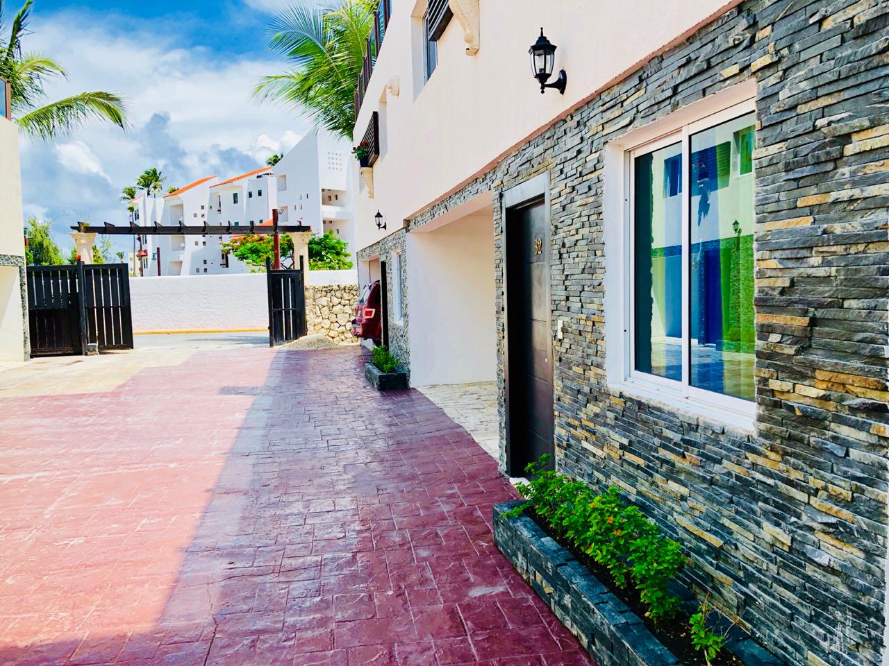 Villa entrance with natural stone facade and tropical landscaping — Punta Cana real estate for sale