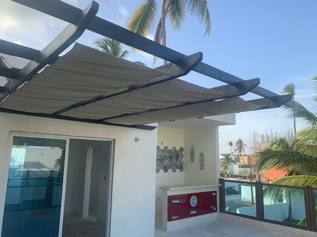 Rooftop pergola with retractable canopy and minibar — luxury villa rooftop in Punta Cana, Dominican Republic